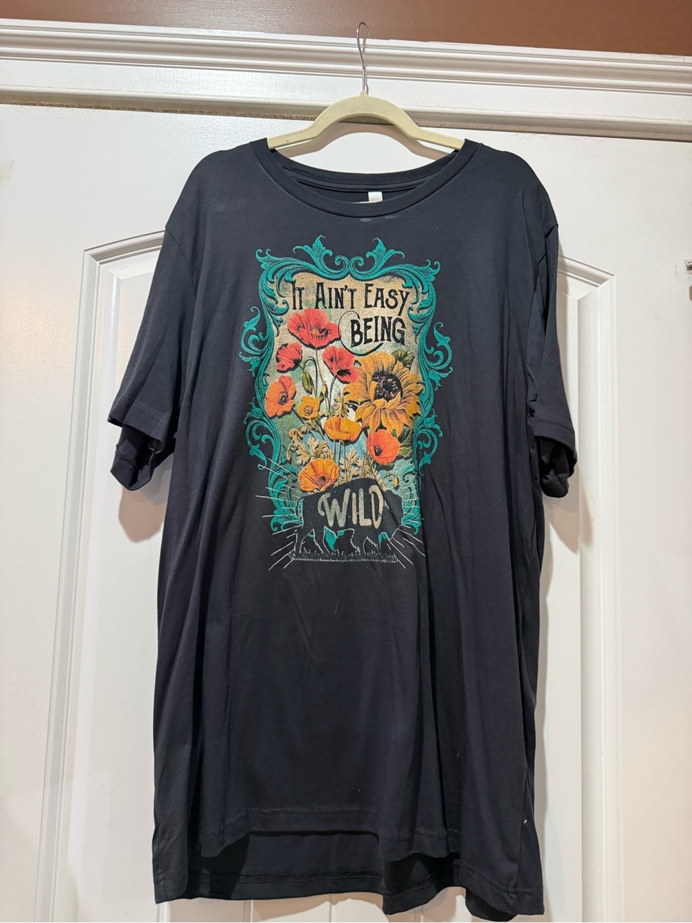 Bella Canvas Black Tee with Teal, Orange & Yellow Floral Graphic